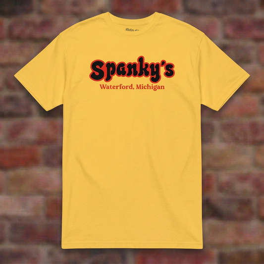 Spanky's Daisy T-shirt flat lay on brick background