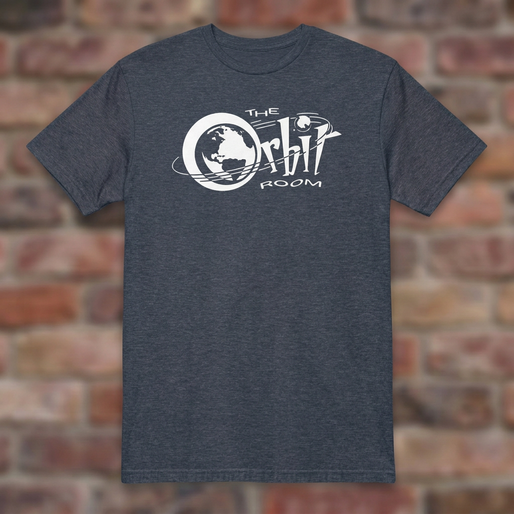 The Orbit Room Heather Navy T-shirt flat lay on weathered brick background