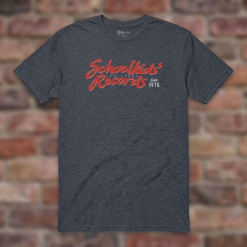 Schoolkids Records Ann Arbor T-shirt in Heather Navy, flat lay on warm brick background