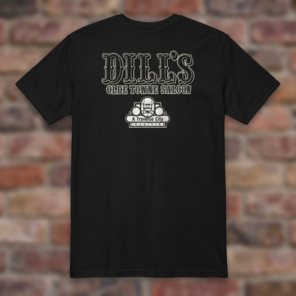 Dill’s Olde Towne Saloon Black T-shirt flat lay on brick background