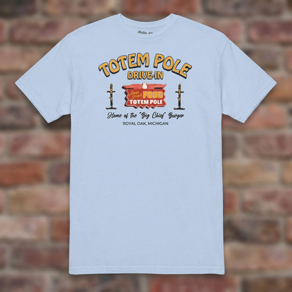 Totem Pole Drive-In Light Blue T-shirt flat lay on brick background