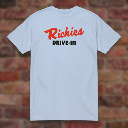 Richies Drive-In Light Blue T-shirt flat lay on brick background