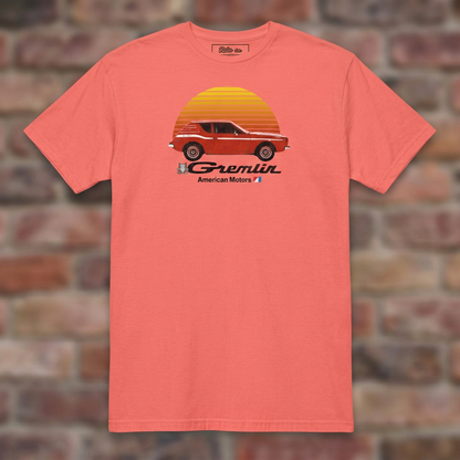 AMC Gremlin Coral Silk T-shirt flat lay on brick background