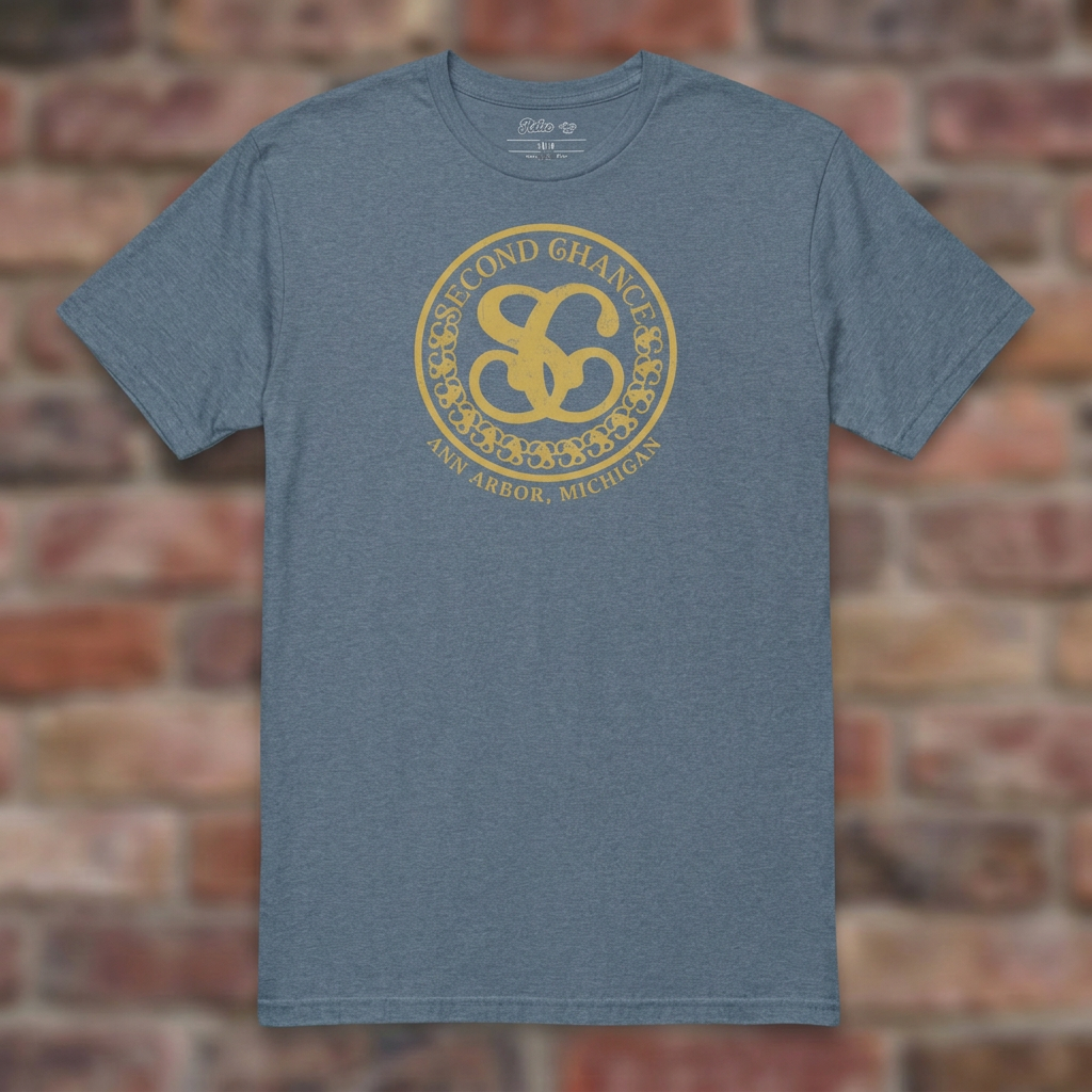 Second Chance Heather Indigo T-shirt flat lay on brick background