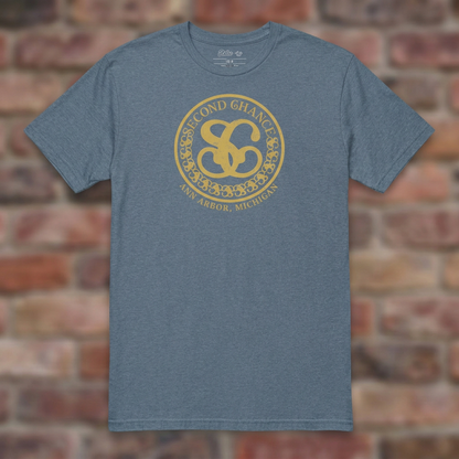 Second Chance Heather Indigo T-shirt flat lay on brick background