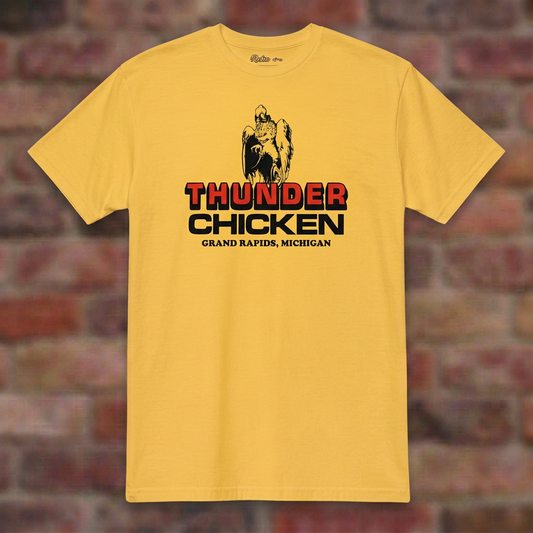 Thunder Chicken Grand Rapids Daisy T-shirt flat lay on brick background