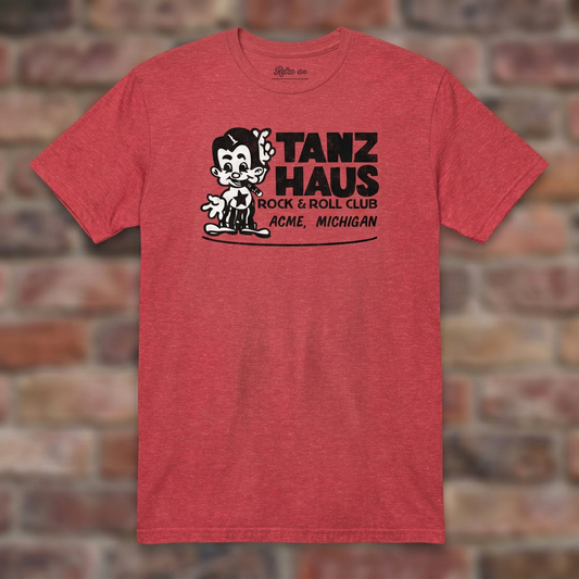 Tanz Haus Heather Red T-shirt flat lay on warm brick