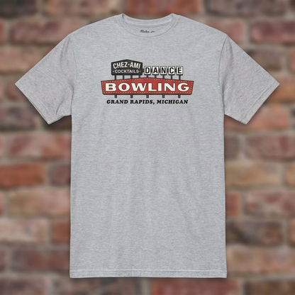 Chez-Ami Lanes Sport Grey T-shirt flat lay on brick background