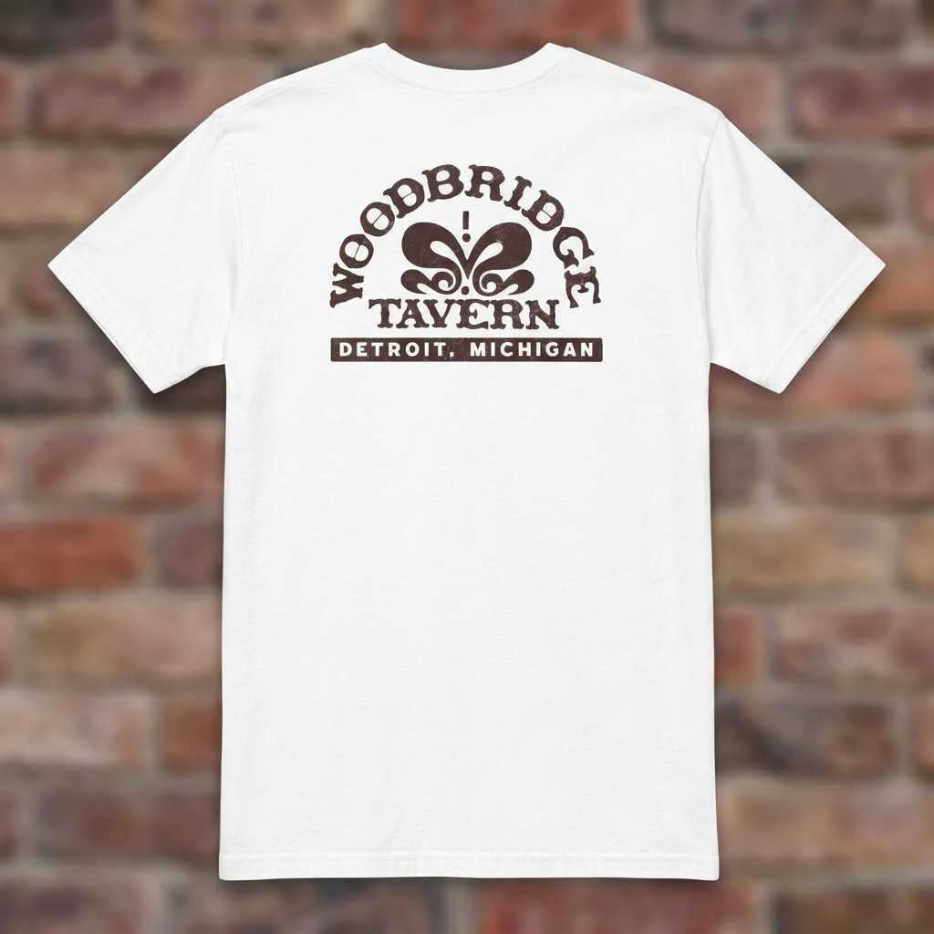 Woodbridge Tavern White T-shirt flat lay on brick background