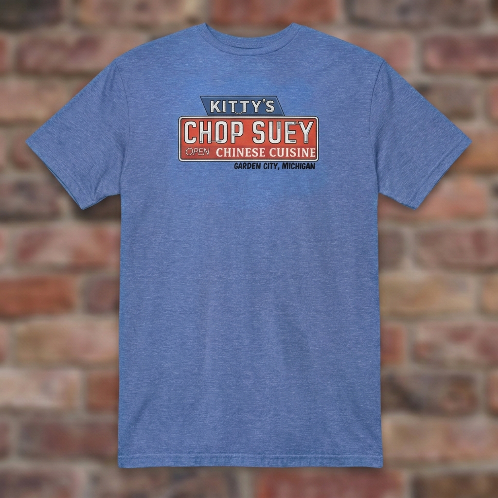 Kitty's Chop Suey Heather Royal T-shirt flat lay on brick background