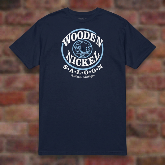 Wooden Nickel Saloon Navy T-shirt flat lay on brick background