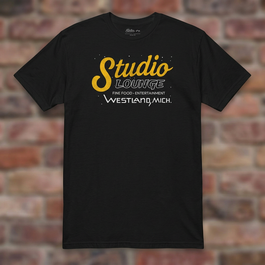 Studio Lounge Black T-shirt flat lay on brick background