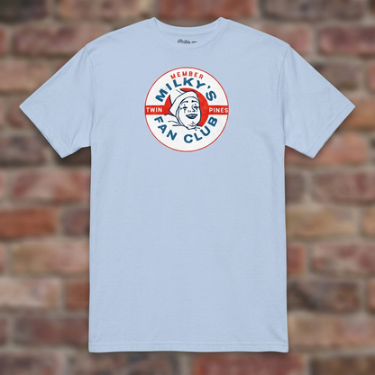 Milky the Clown Fan Club T-shirt in Light Blue, flat lay on warm brick background