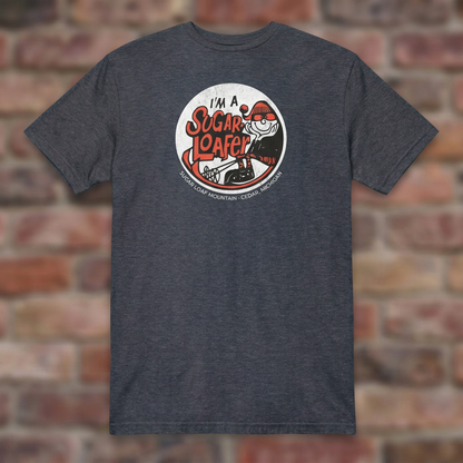 I'm a Sugar Loafer T-shirt in Heather Navy, flat lay on warm brick background