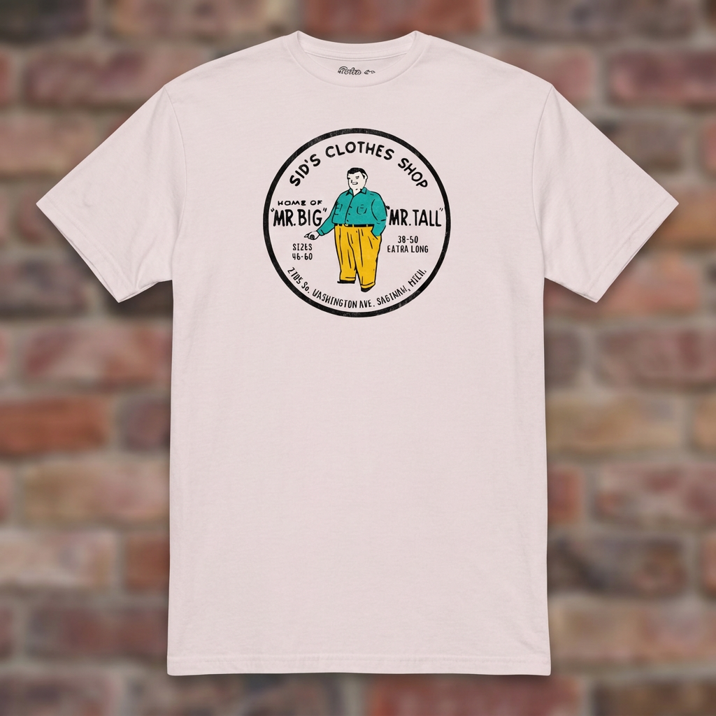 Sid's Clothing Shop Saginaw T-shirt in Ice Grey, flat lay on warm brick background