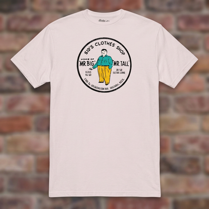 Sid's Clothing Shop Saginaw T-shirt in Ice Grey, flat lay on warm brick background