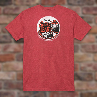 I'm a Sugar Loafer T-shirt in Heather Red, flat lay on warm brick background