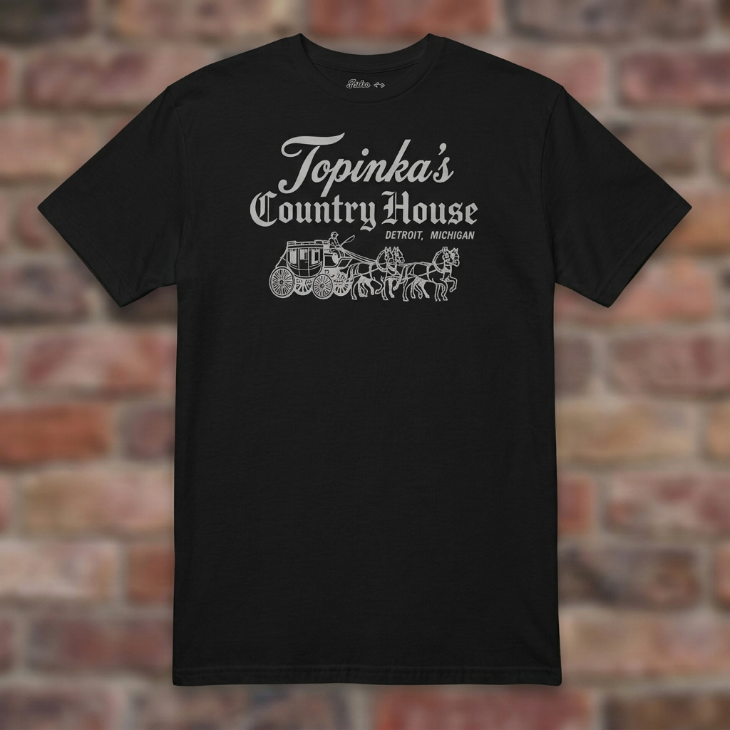 Topinka's Black T-shirt flat lay on brick background