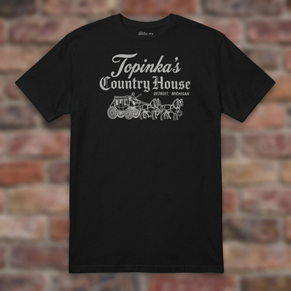 Topinka's Black T-shirt flat lay on brick background
