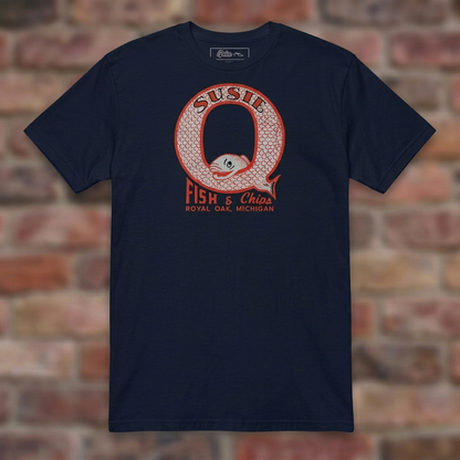 Susie Q Fish-n-Chips Navy T-shirt flat lay on brick background