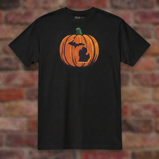 Mich O' Lantern Black T-shirt flat lay on brick background