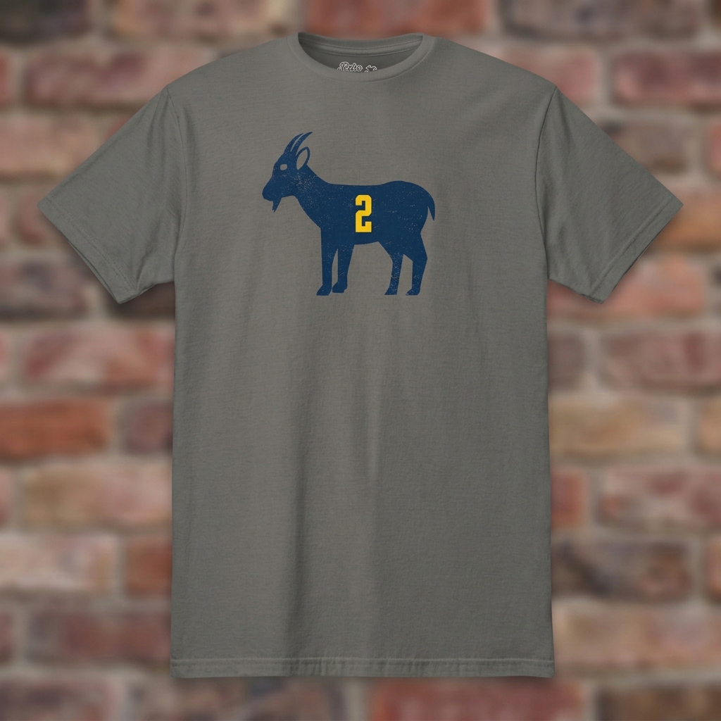 Charcoal GOAT Woodson T-shirt flat-lay against weathered brick