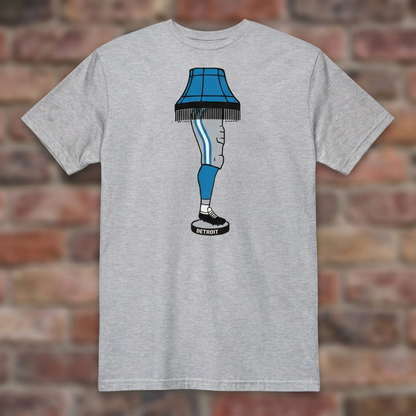 Sport Grey Detroit Football Leg Lamp T-shirt flat-lay against weathered brick