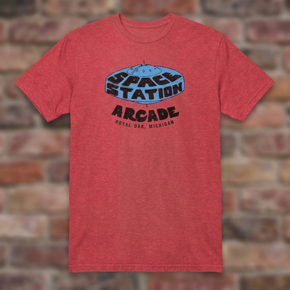Space Station Arcade Heather Red T-shirt flat lay on brick background