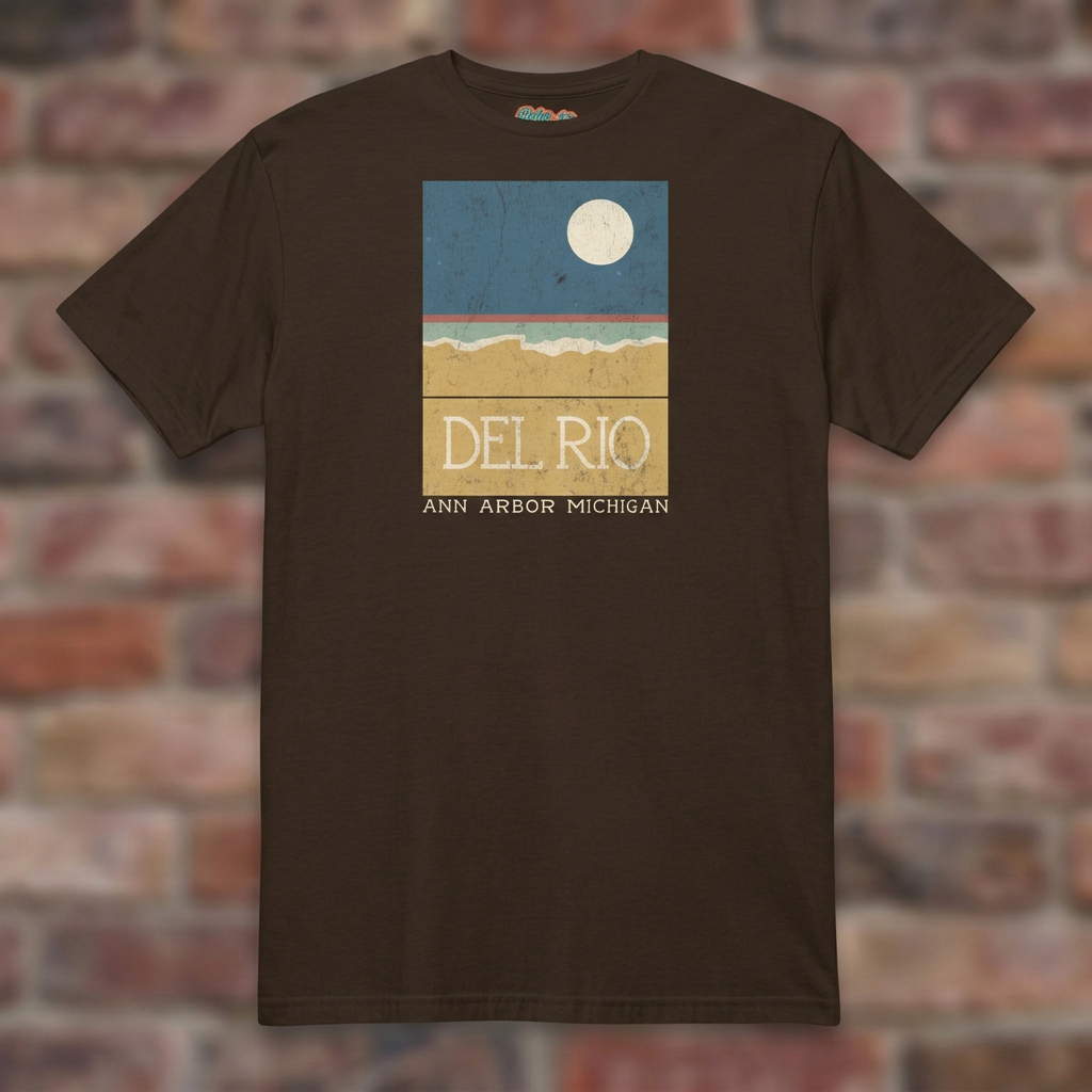 Del Rio Ann Arbor Dark Chocolate T-shirt flat lay on brick background