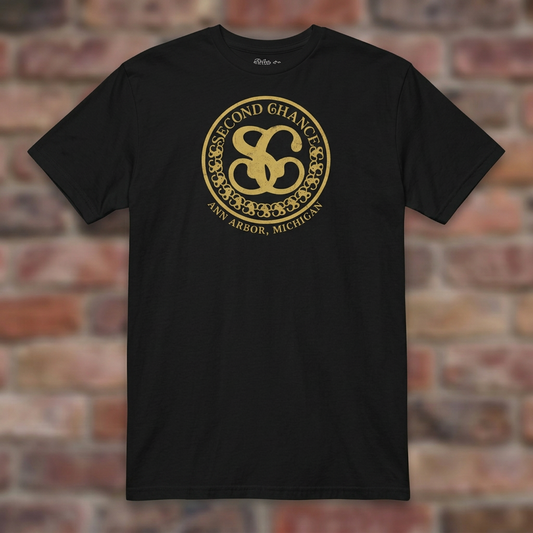 Second Chance Black T-shirt flat lay on brick background