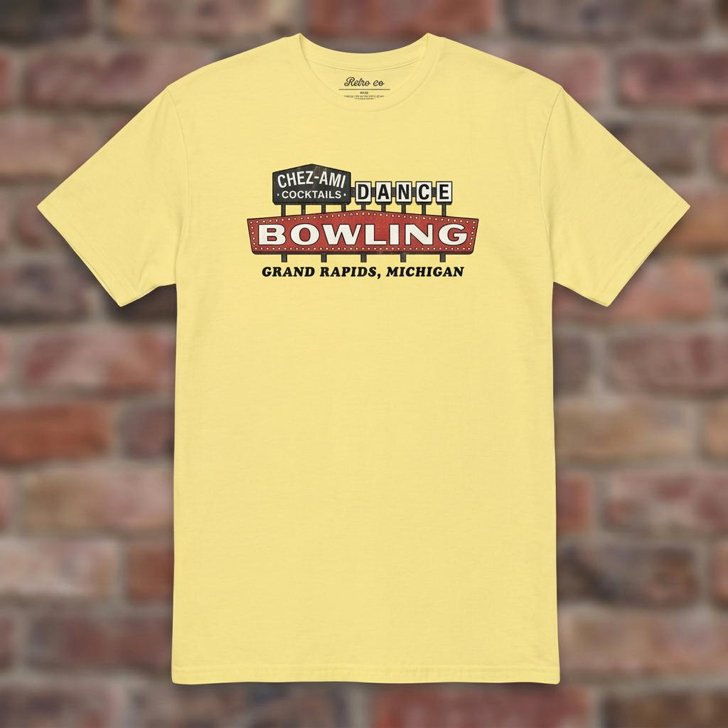 Chez-Ami Lanes Cornsilk T-shirt flat lay on brick background