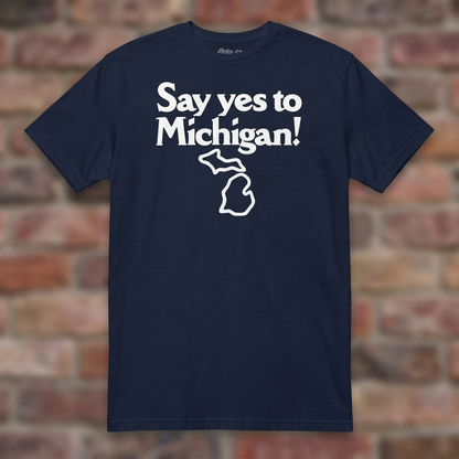 Say yes to Michigan Navy T-shirt flat lay on brick background