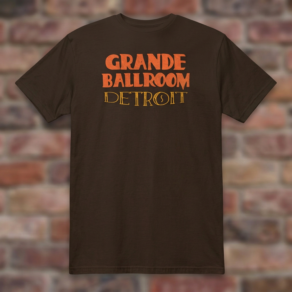 Grande Ballroom Detroit Dark Chocolate T-shirt flat lay on brick background