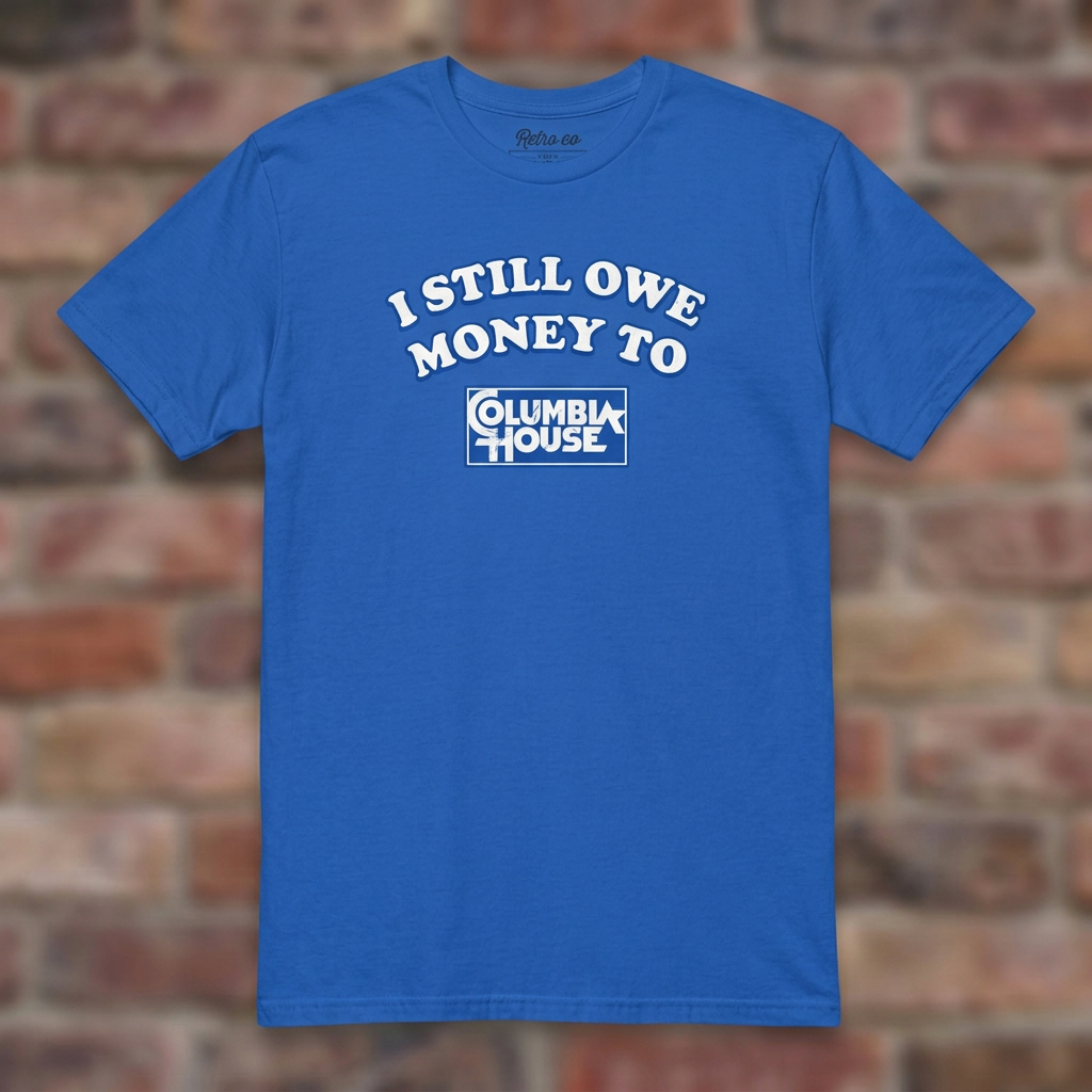 I Still Owe Money To Columbia House Royal T-shirt flat lay on brick background