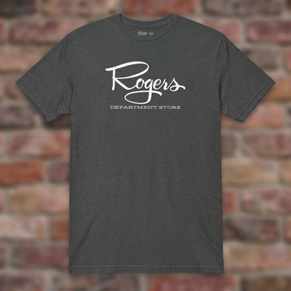 Roger's Department Store T-shirt in Dark Heather Grey, flat lay on warm brick background