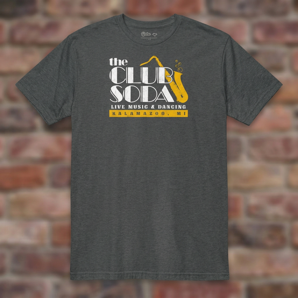 The Club Soda Kalamazoo T-shirt in Dark Heather Grey on a weathered brick background