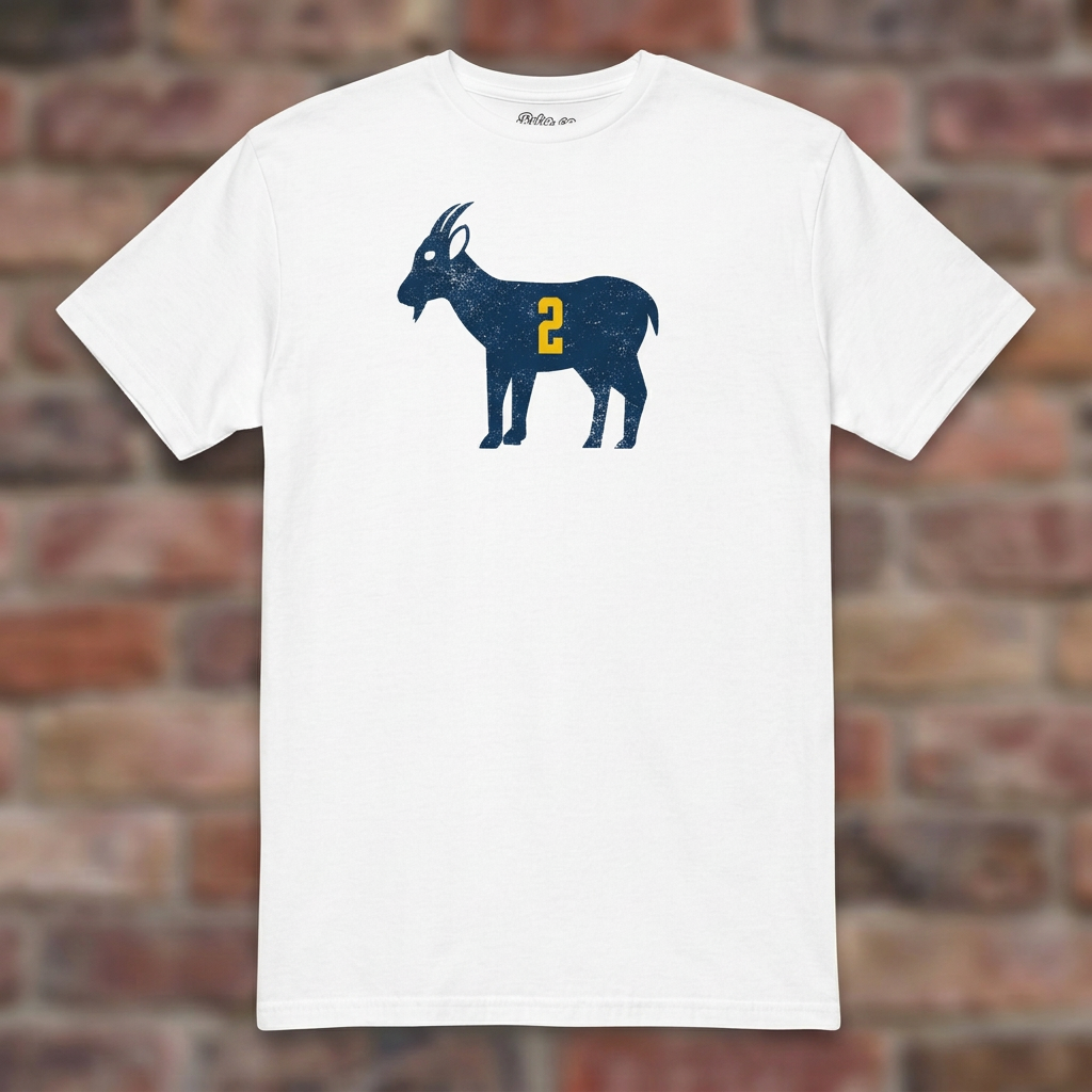 White GOAT Woodson T-shirt flat-lay against weathered brick