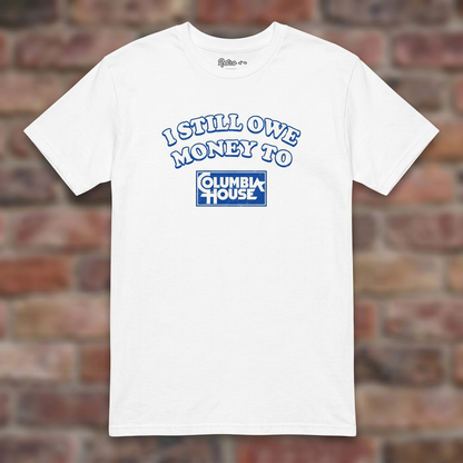 I Still Owe Money To Columbia House White T-shirt flat lay on brick background