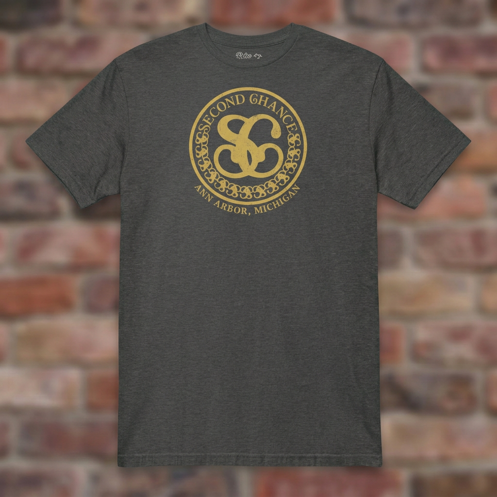 Second Chance Dark Heather Grey T-shirt flat lay on brick background
