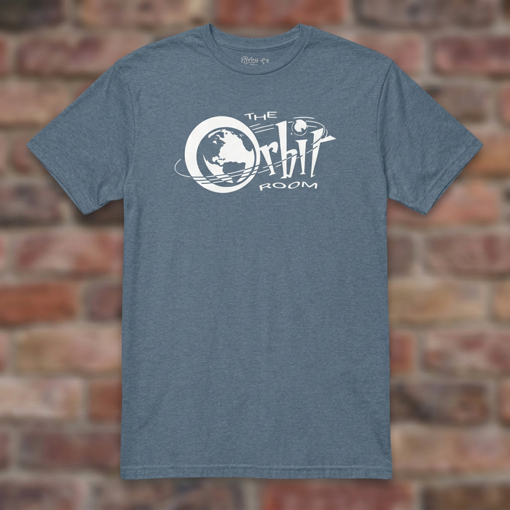 The Orbit Room Heather Indigo T-shirt flat lay on weathered brick background