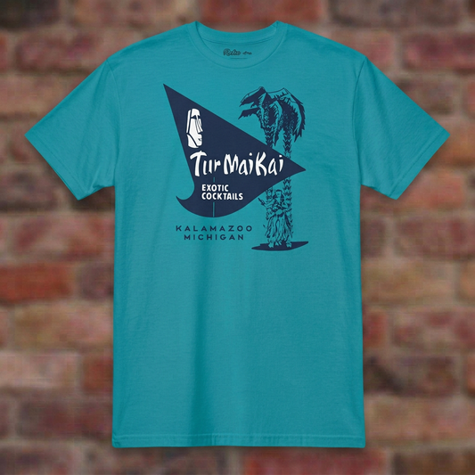 Tur Mai Kai Kalamazoo Tropical Blue T-shirt flat lay on brick background