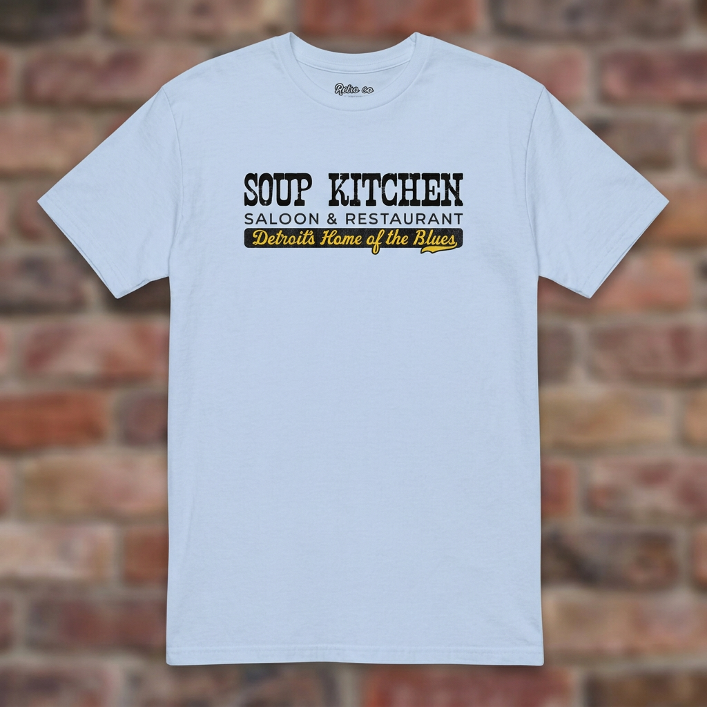 Soup Kitchen Saloon Light Blue T-shirt flat lay on brick background