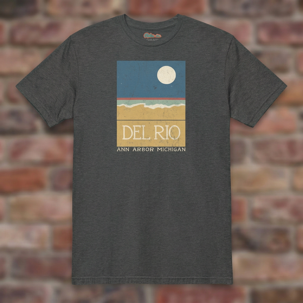 Del Rio Ann Arbor Dark Heather Grey T-shirt flat lay on brick background
