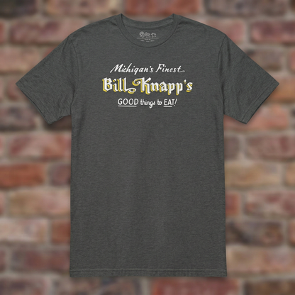 Dark Heather Grey Bill Knapp’s T-shirt flat lay on warm brick background