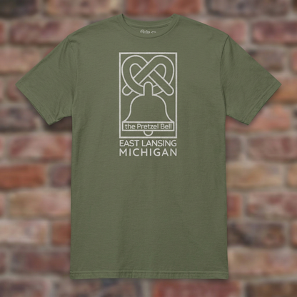 The Pretzel Bell East Lansing Military Green T-shirt flat lay on brick background