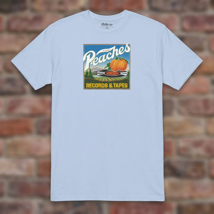Peaches Records & Tapes Light Blue T-shirt flat lay on brick background