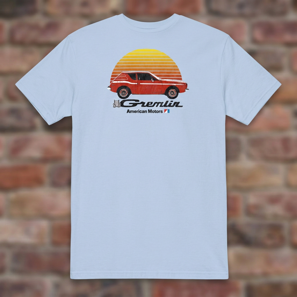 AMC Gremlin Light Blue T-shirt flat lay on brick background