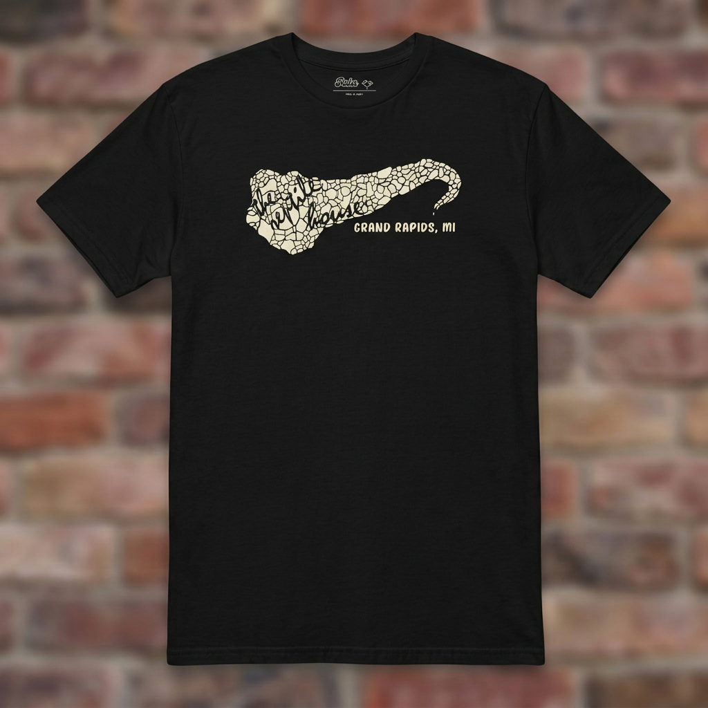 The Reptile House Grand Rapids Black T-shirt flat lay on brick background