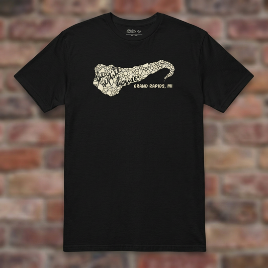 The Reptile House Grand Rapids Black T-shirt flat lay on brick background