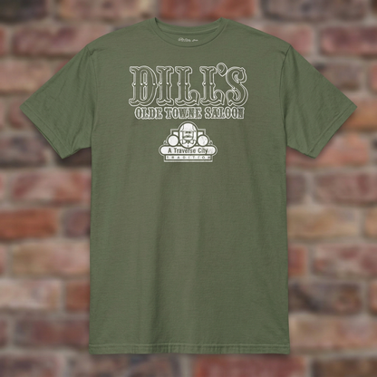 Dill’s Olde Towne Saloon Military Green T-shirt flat lay on brick background
